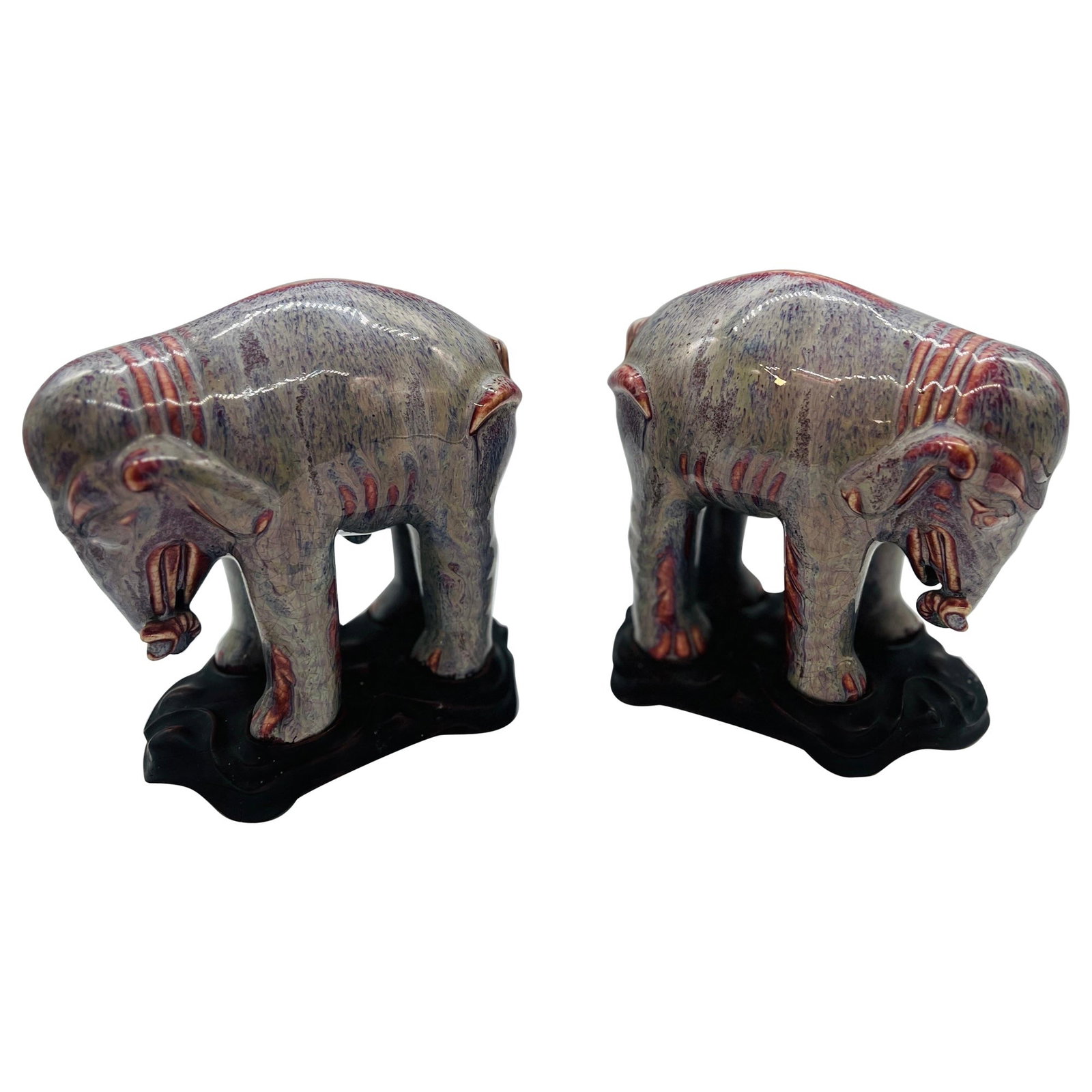 Pair of 19th Century Chinese Flambe Glazed Porcelain Elephants: Pair of 19th Century Chinese Flambe Glazed Porcelain Elephants This stunning pair of antique Chinese porcelain elephants showcases exquisite craftsmanship from the 19th century. Each elephant is a mod