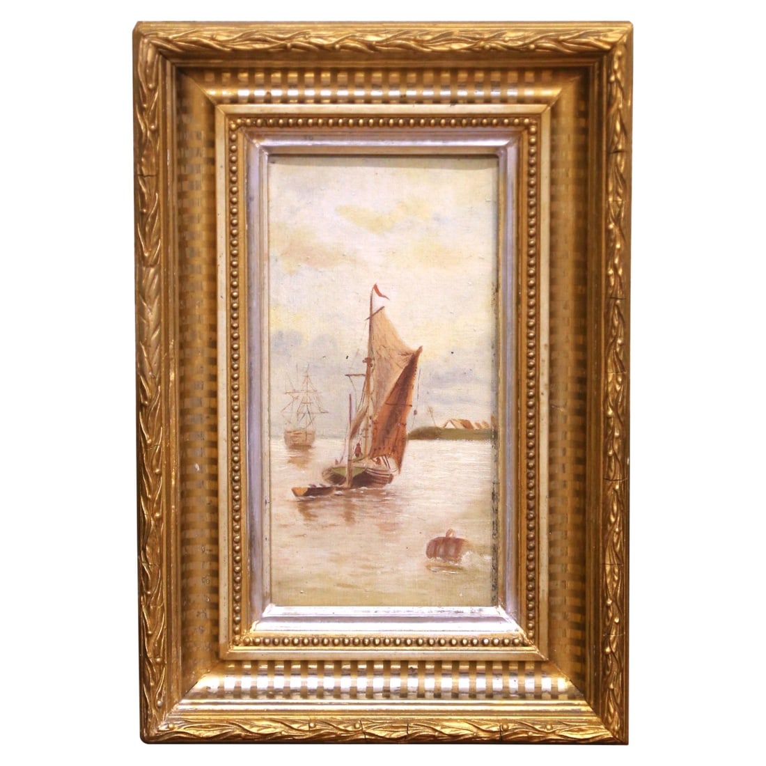 French 19th Century Harbor Oil Painting in Giltwood Frame: French 19th Century Harbor Oil Painting in Giltwood Frame This late 19th-century French oil on canvas painting features a serene coastal harbor scene with a sailboat in the foreground and a larger ves