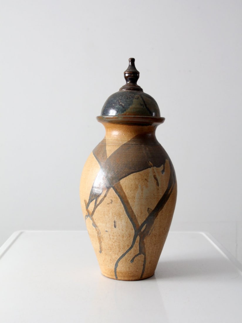 Signed Vintage Studio Pottery Vase with Drip Glaze 19 Inch: Signed Vintage Studio Pottery Vase with Drip Glaze 19 Inch This stunning vintage studio pottery vase features a dynamic hand-crafted urn design with a bold drip glaze cascading down its lid. The vase 