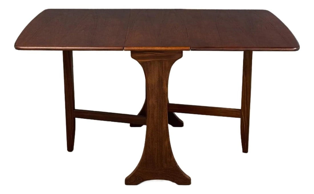Mid Century Modern Refinished Teak Drop Leaf Dining Table: Mid Century Modern Refinished Teak Drop Leaf Dining Table This exquisite mid-century modern teak drop leaf dining table seamlessly combines style and functionality. Perfect for small spaces, this tabl