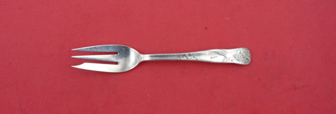 Tiffany & Co Sterling Silver Lap Over Edge Oyster Fork with Bird and Tree 5": Tiffany & Co Sterling Silver Lap Over Edge Oyster Fork with Bird and Tree 5" Experience timeless elegance with this exquisite oyster fork by Tiffany & Co. Crafted from high-quality sterling silver (.9