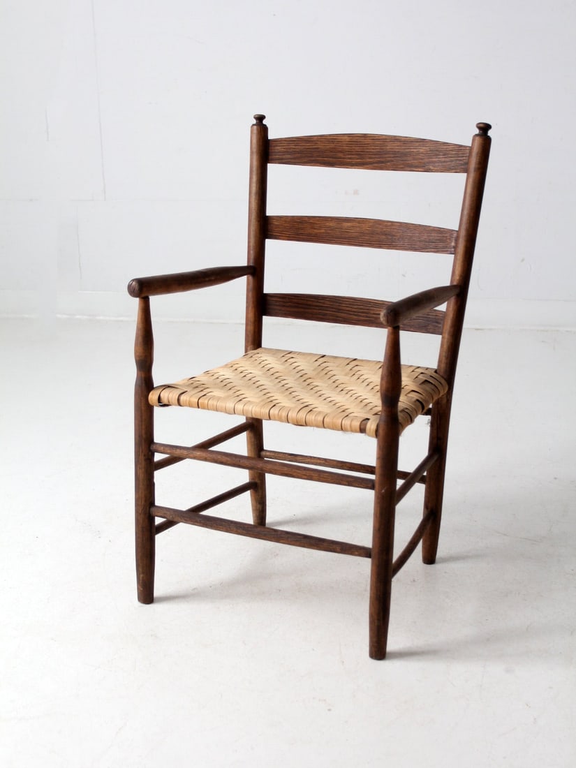 Classic Shaker Antique Armchair with Woven Cane Seat: Classic Shaker Antique Armchair with Woven Cane Seat This antique armchair features a classic Shaker style, highlighted by its woven herringbone cane seat. Its timeless rustic design makes it a versat