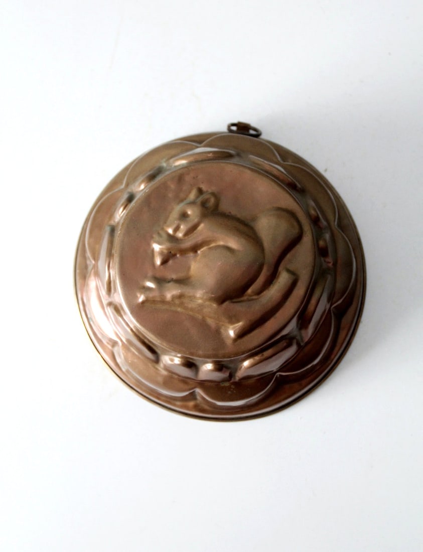 Vintage Copper Squirrel Mold 8.375 inch Tiered Design: Vintage Copper Squirrel Mold 8.375 inch Tiered Design This antique copper mold features a charming squirrel design and a unique tiered shape that adds character to any kitchenware collection. The intr