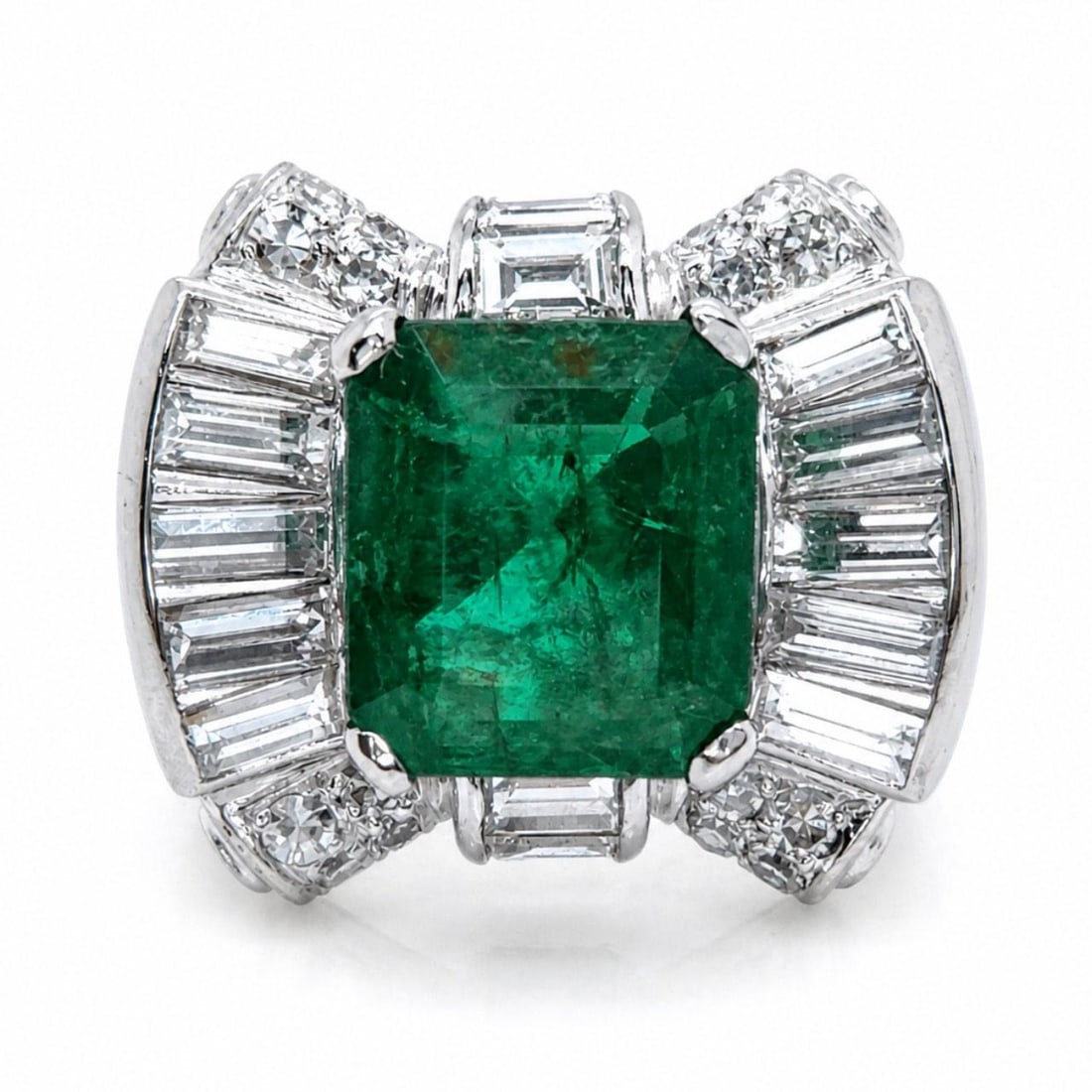 Platinum Art Deco Emerald Diamond Ring 5.5 Size: Platinum Art Deco Emerald Diamond Ring 5.5 Size This Art Deco ring features a platinum setting adorned with an approximately 5.50 carat emerald. The ring is further accented by 16 baguette diamonds to