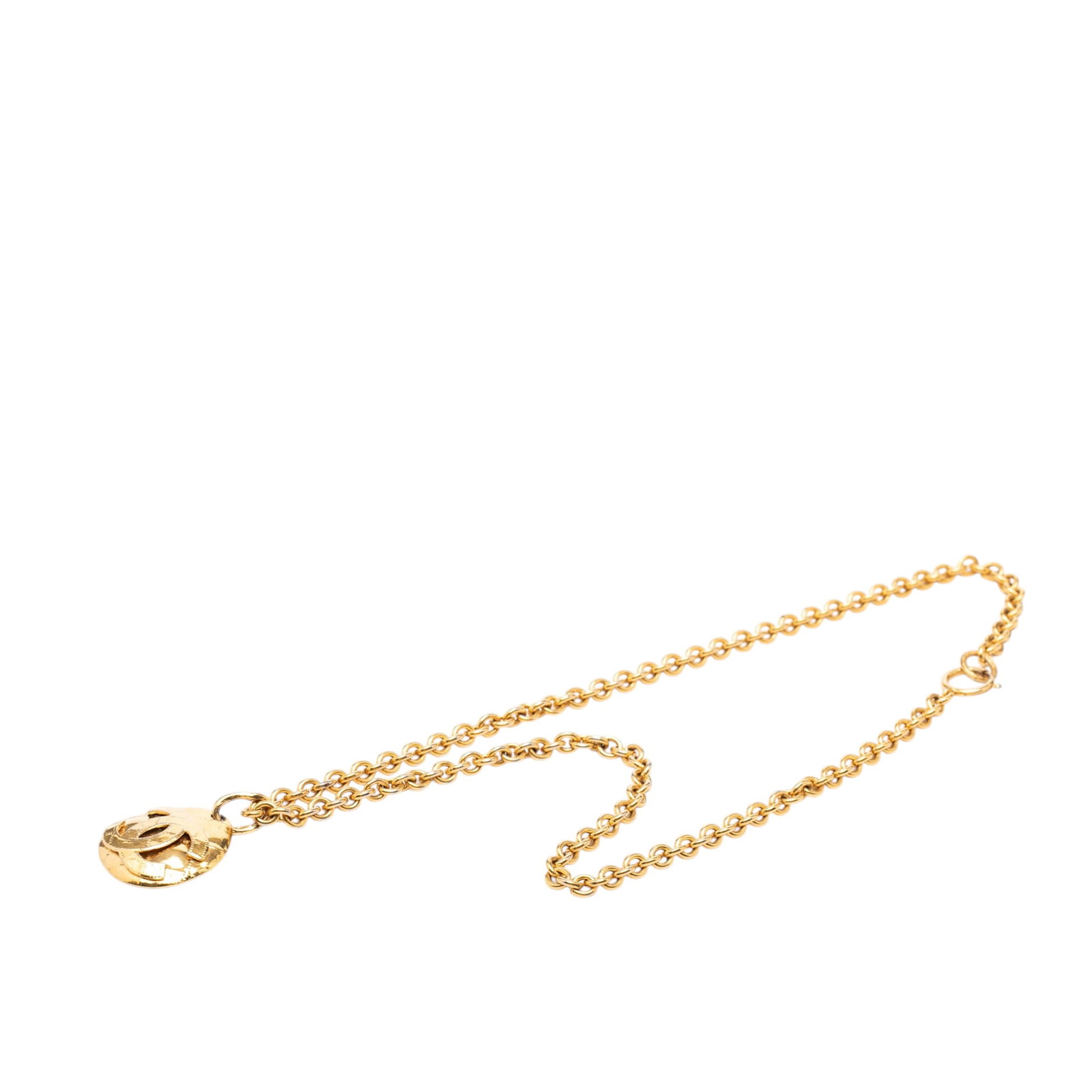 Chanel Quilted Oval CC Pendant Necklace Gold Plated: Chanel Quilted Oval CC Pendant Necklace Gold Plated This Chanel necklace features a gold tone metal body with a quilted oval pendant showcasing the iconic CC logo. It is designed with a spring ring cl