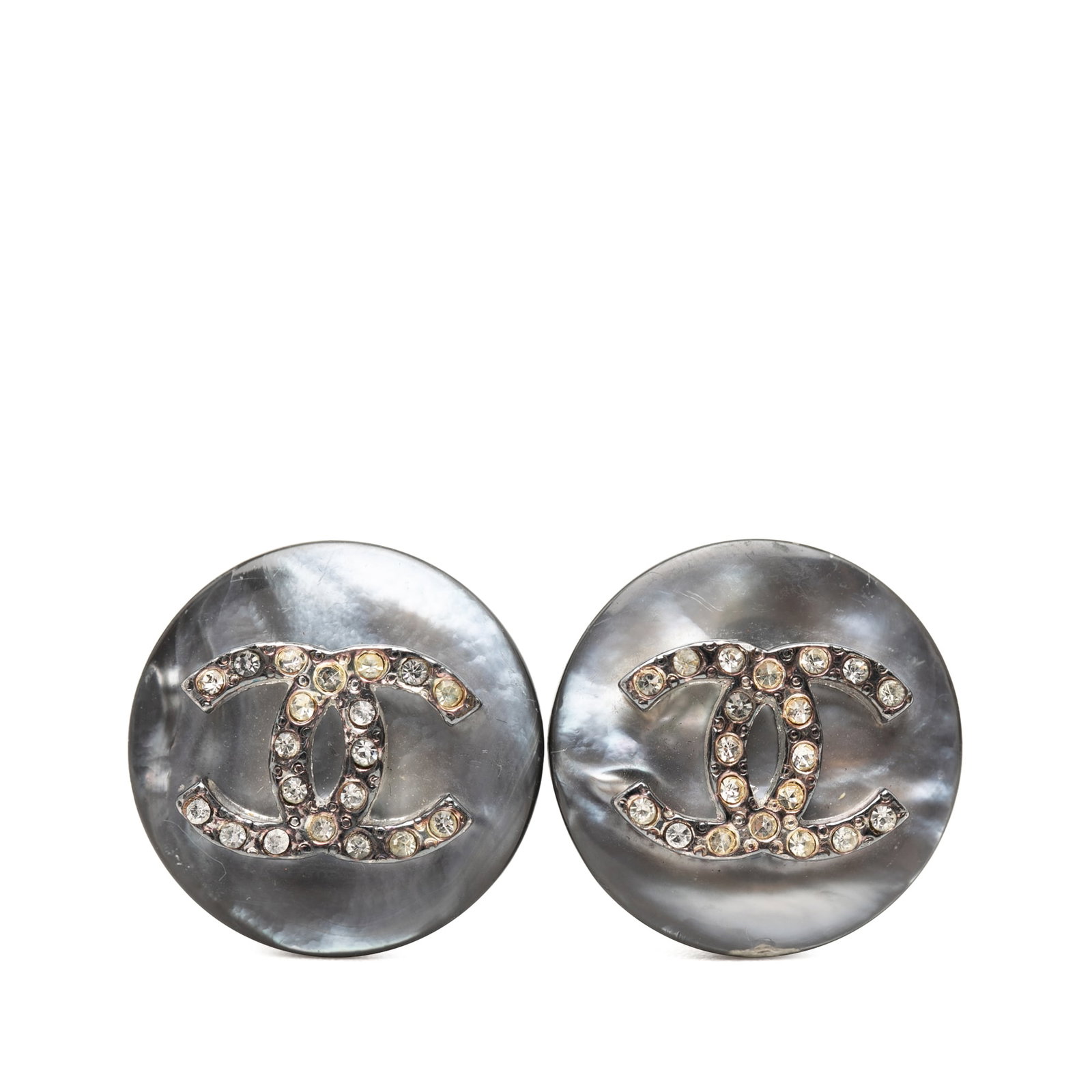 Chanel silver tone strass clip on earrings: Chanel silver tone strass clip on earrings These Chanel CC earrings feature silver tone metal bodies adorned with strass embellishments and are designed with secure clip-on closures. Crafted in France