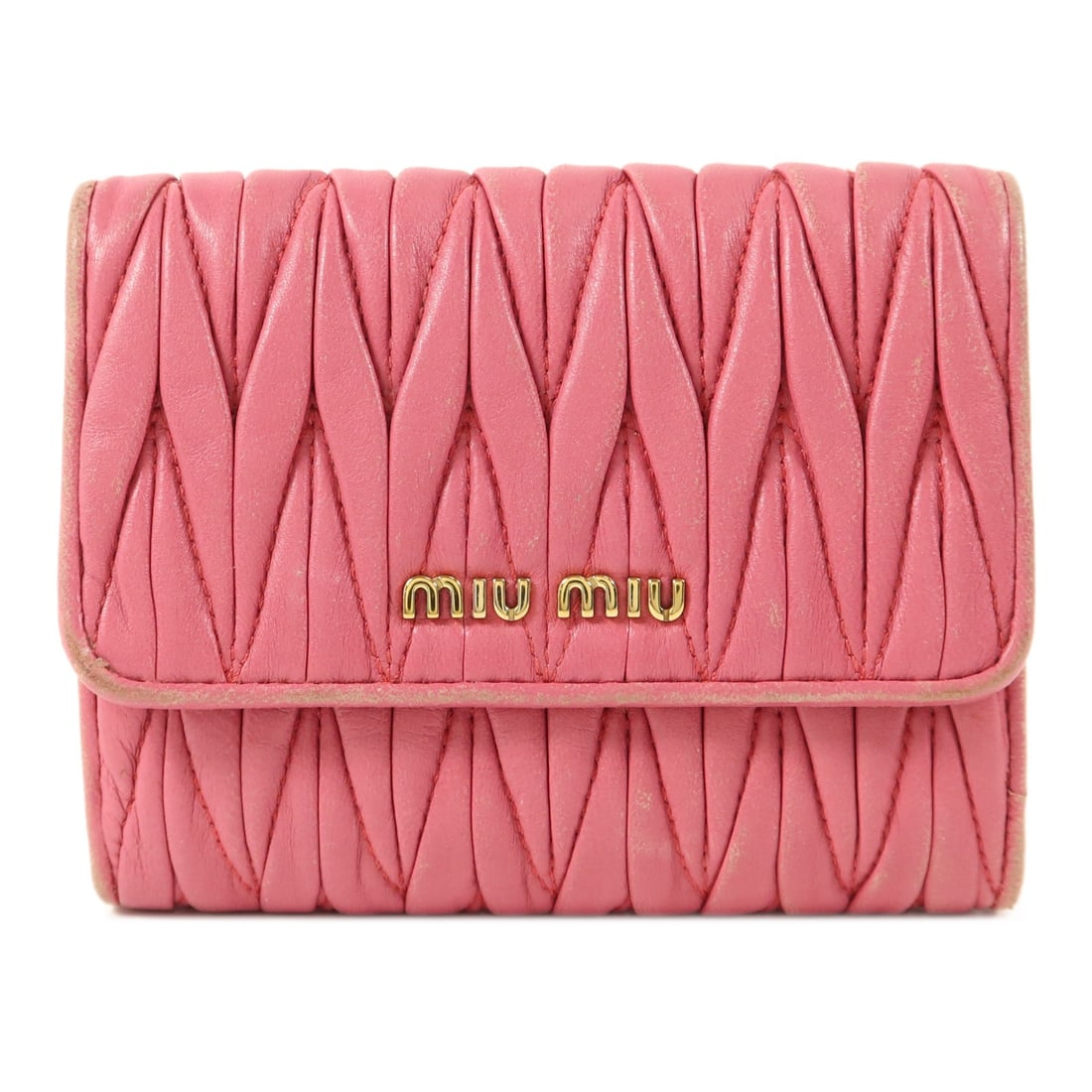 Miu Miu Pink Lambskin Bi fold Wallet GHW: Miu Miu Pink Lambskin Bi fold Wallet GHW This Miu Miu bi-fold wallet is crafted from soft lambskin leather in a pink hue. Designed for women, it features a matelasse texture and gold-tone hardware. Ma