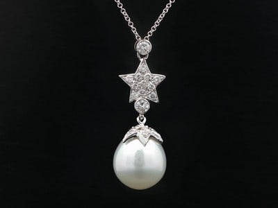 South Sea Pearl Diamond Star Pendant Necklace 18k White Gold: South Sea Pearl Diamond Star Pendant Necklace 18k White Gold This elegant pendant necklace features a genuine cultured South Sea pearl in a round button shape, accented by a double star dangle