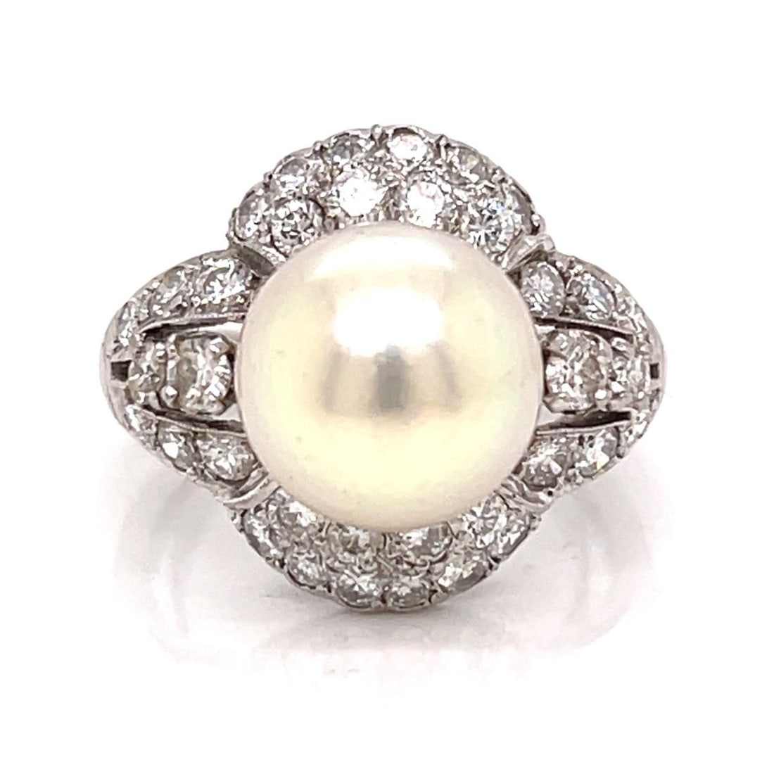 Platinum Ring Featuring 10.9mm Pearl and 36 Diamonds Circa 1950s: Platinum Ring Featuring 10.9mm Pearl and 36 Diamonds Circa 1950s This 1950s platinum ring features a central 10.9mm pearl surrounded by 36 diamonds with an approximate total weight of 2.00 carats,