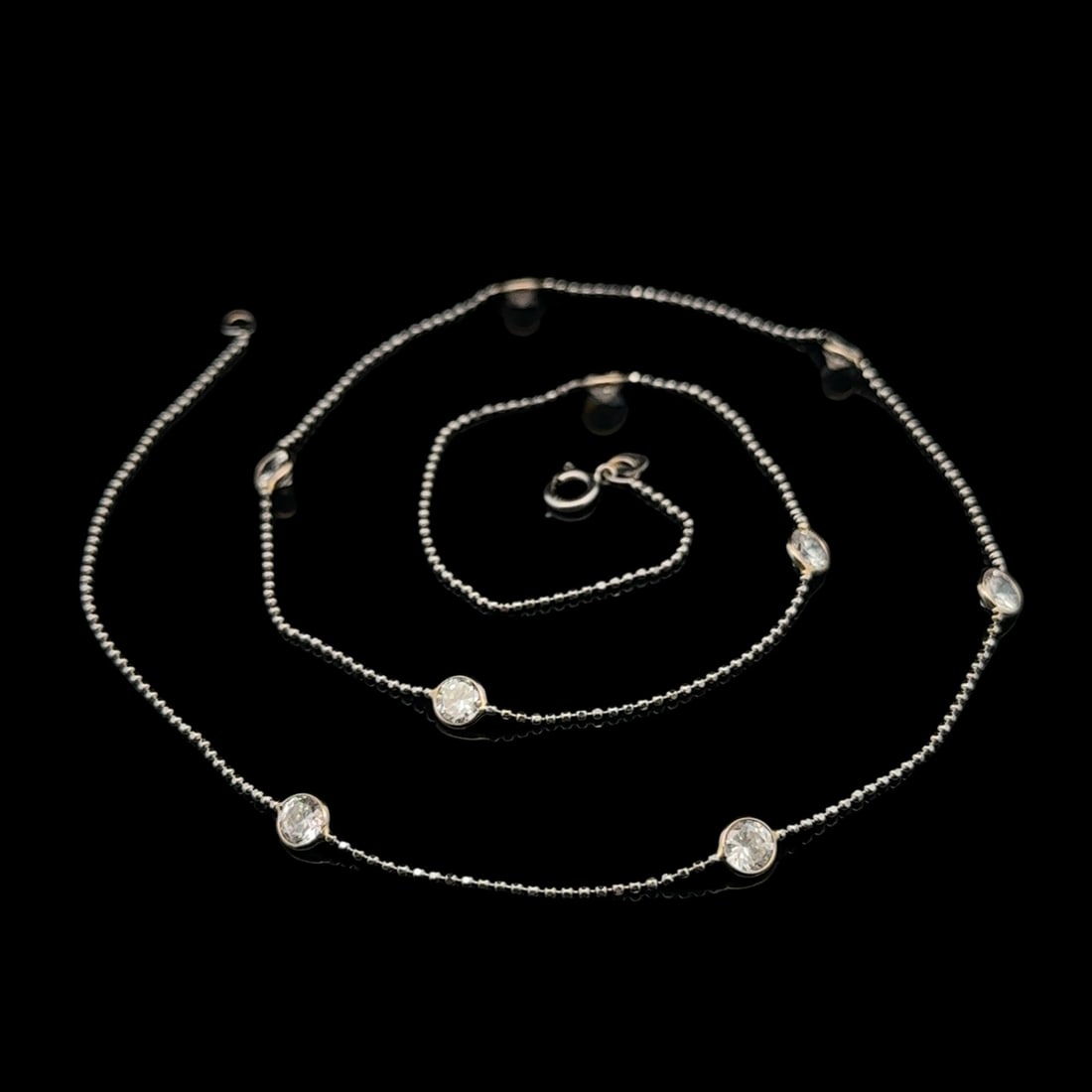Vintage 14k White Gold 18 Inch Cubic Zirconia Bead Station Necklace: Vintage 14k White Gold 18 Inch Cubic Zirconia Bead Station Necklace This exquisite vintage necklace showcases a classic design crafted from 14k solid white gold. The necklace features nine round
