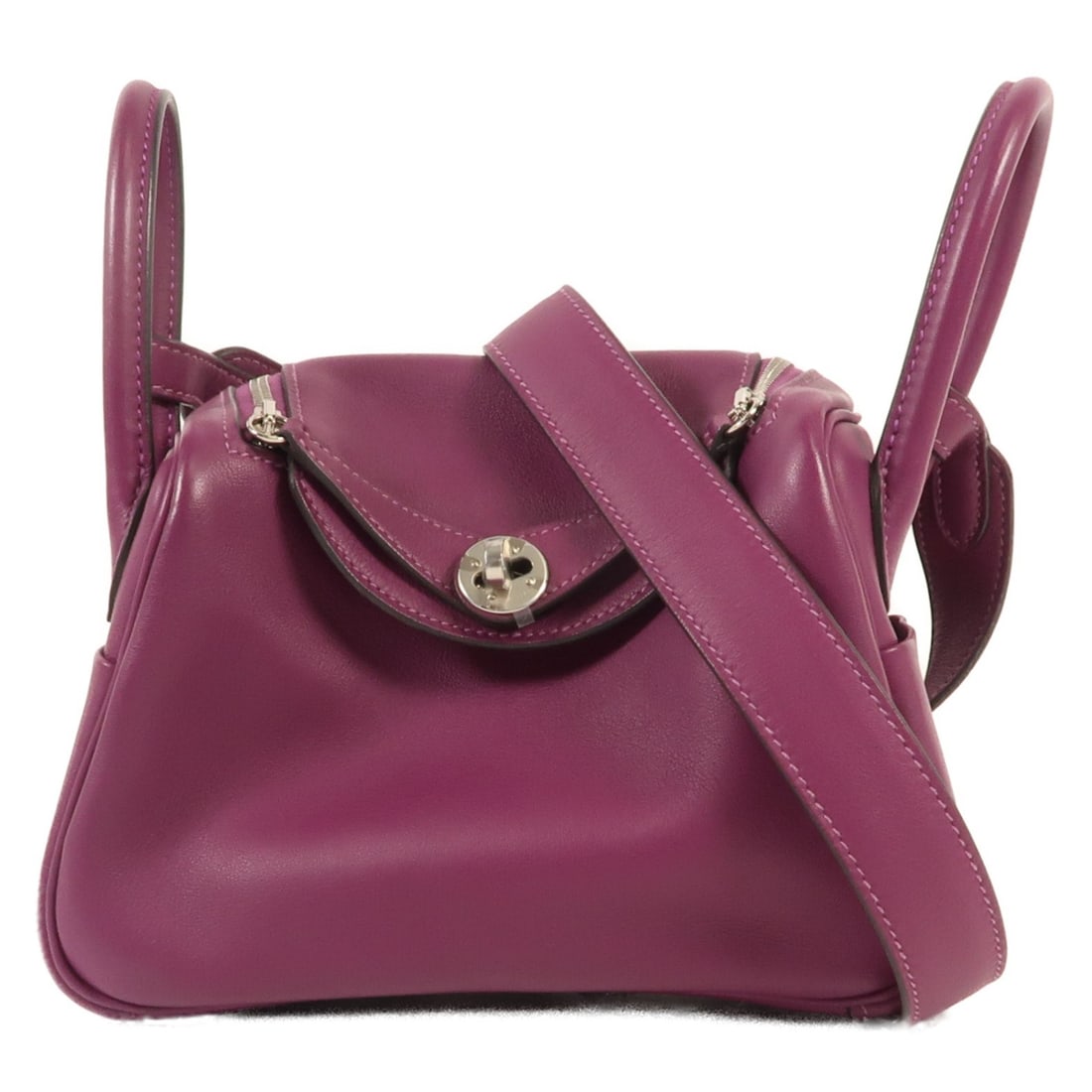Hermes Mini Lindy Anemone Purple Calfskin 2 Way Shoulder Bag: Hermes Mini Lindy Anemone Purple Calfskin 2 Way Shoulder Bag This Hermes Mini Lindy 2-way bag is crafted from supple Swift calfskin leather in a striking purple color. Designed for versatility, it can