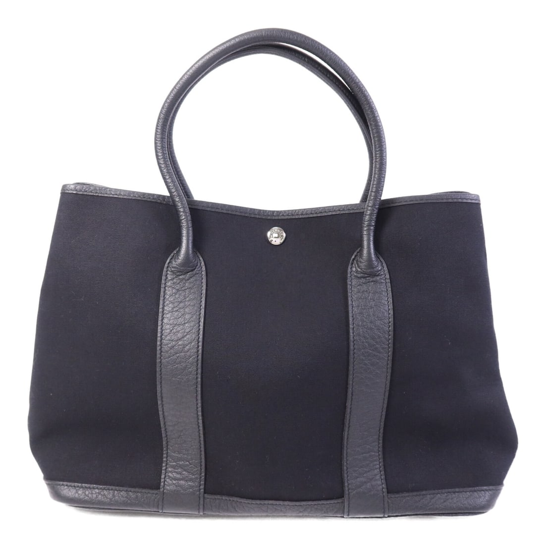 GardenParty PM black canvas tote with palladium hardware by Hermes: GardenParty PM black canvas tote with palladium hardware by Hermes This Hermes Garden Party PM tote bag features a black canvas exterior and is designed for women. It offers ample space with its struc