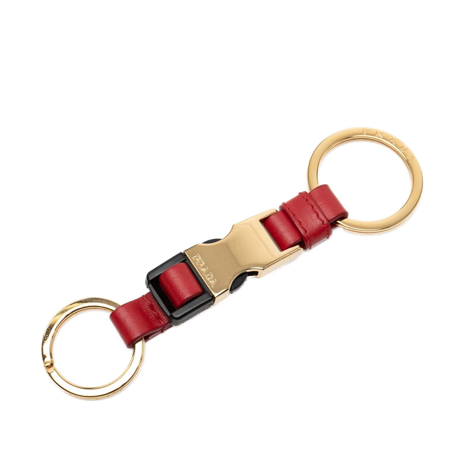 Prada red leather key holder with split rings: Prada red leather key holder with split rings This Prada City Calf Leather Tuc Key Ring features a red leather body, two split rings, and a push-lock tuc buckle closure. Made in Italy, it is designed 
