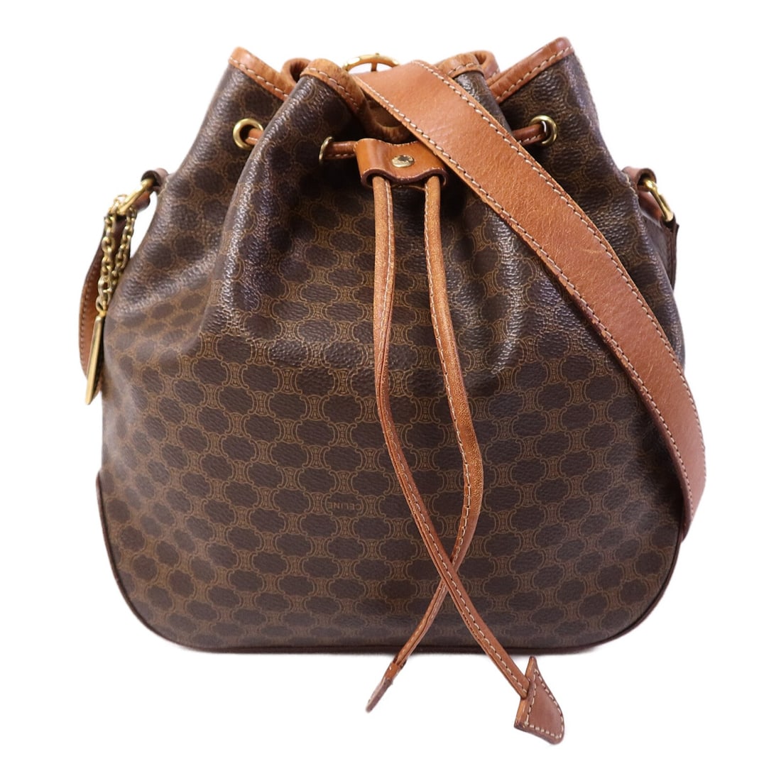 CELINE vintage brown PVC coated canvas bucket shoulder bag GHW: CELINE vintage brown PVC coated canvas bucket shoulder bag GHW This vintage CELINE shoulder bag features a classic bucket design crafted from durable brown PVC coated canvas. The bag offers a spacious
