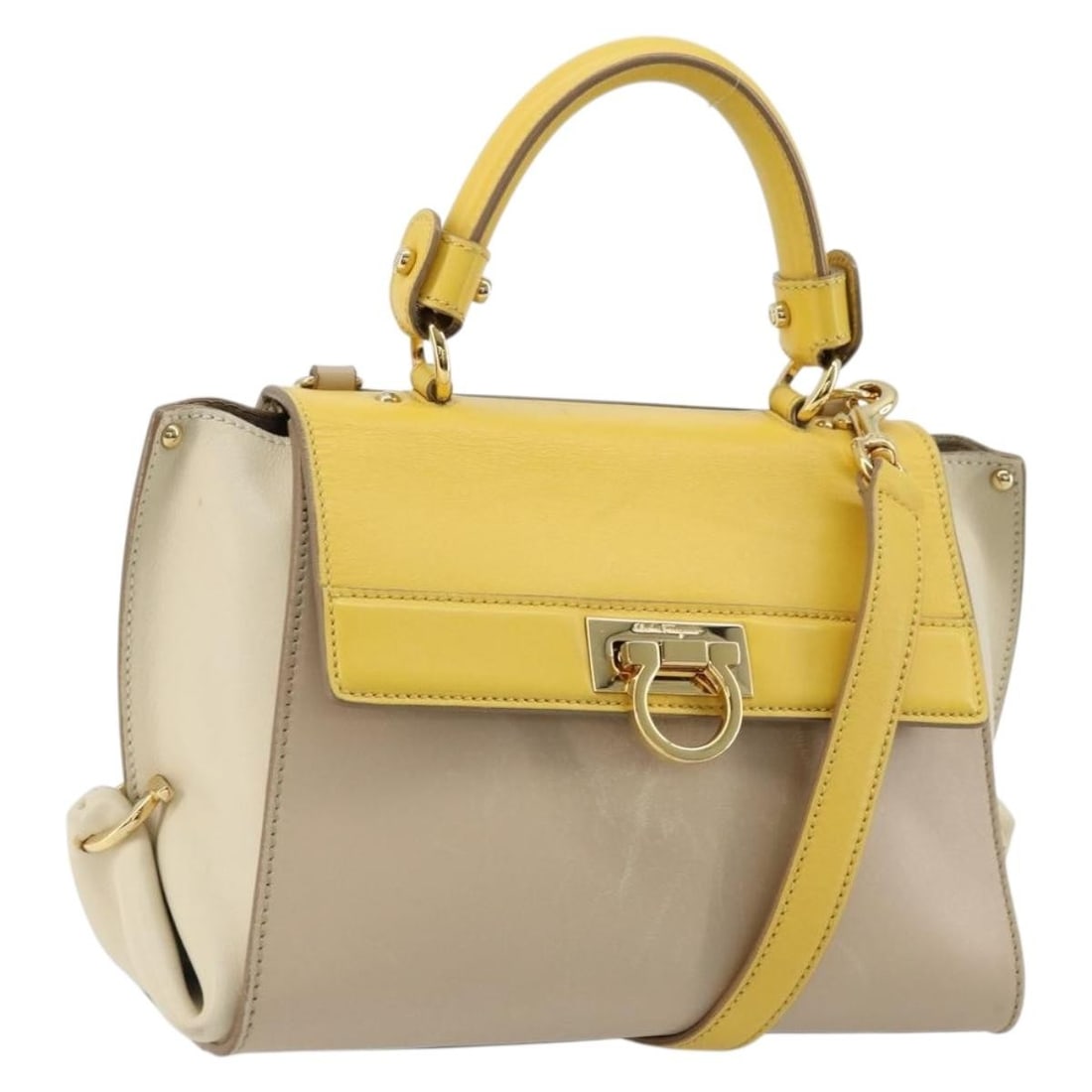 Salvatore Ferragamo Gancini leather 2way beige yellow handbag with shoulder strap: Salvatore Ferragamo Gancini leather 2way beige yellow handbag with shoulder strap This Salvatore Ferragamo Gancini handbag is crafted from leather in a beige and yellow color combination. Designed for