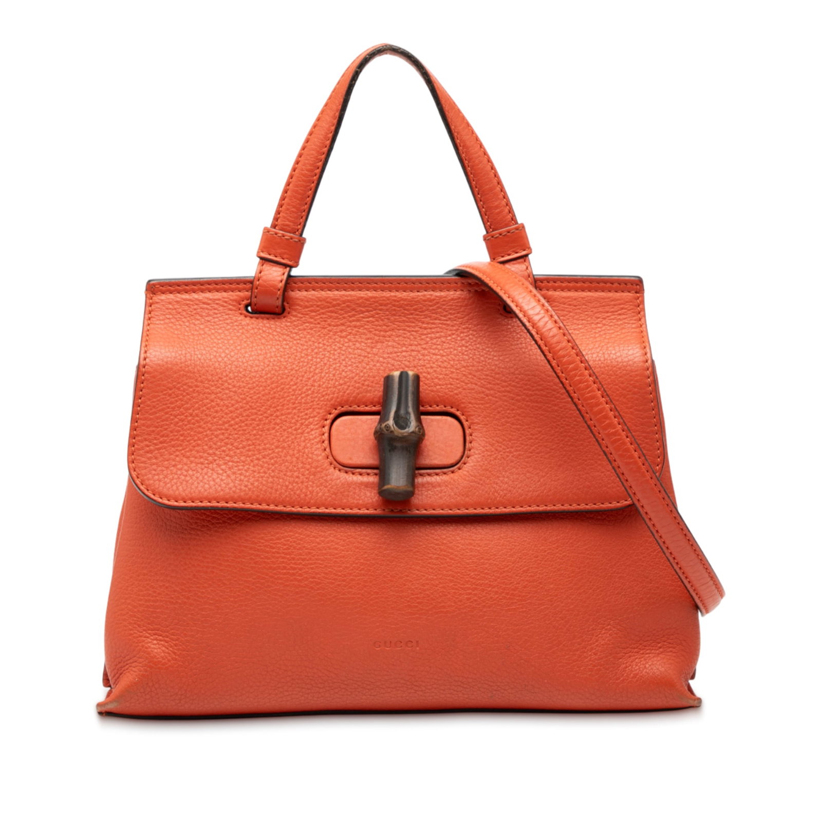 Gucci orange leather satchel with bamboo twist lock: Gucci orange leather satchel with bamboo twist lock This Gucci Small Leather Bamboo Daily Satchel features an orange leather body, a flat top handle, a detachable flat strap, and a front flap with a s