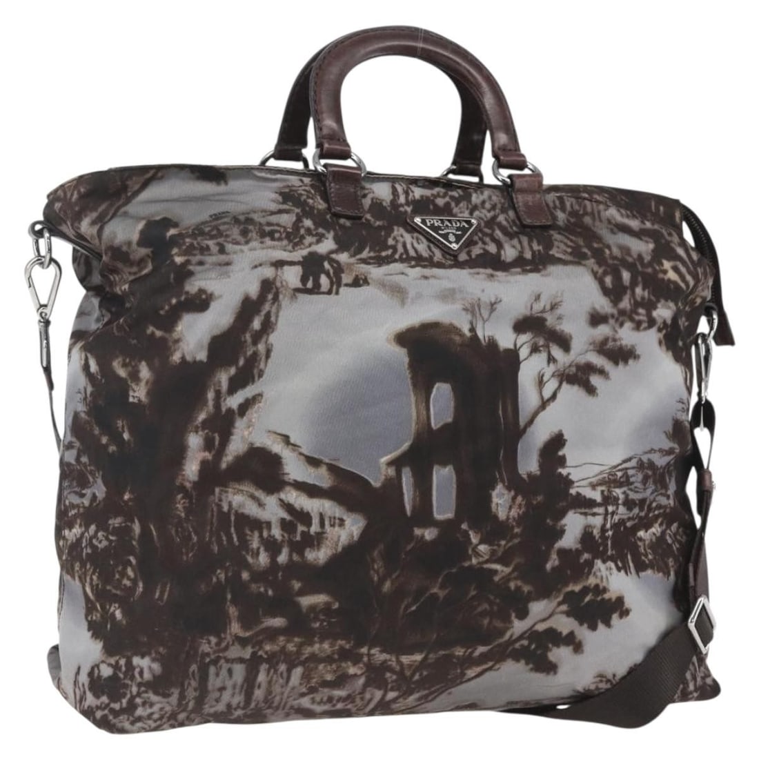 Prada nylon brown silver women s shoulder tote with strap dust bag: Prada nylon brown silver women s shoulder tote with strap dust bag This PRADA handbag offers versatile 2-way carrying options with both handles and an adjustable shoulder strap. Crafted from brown nyl
