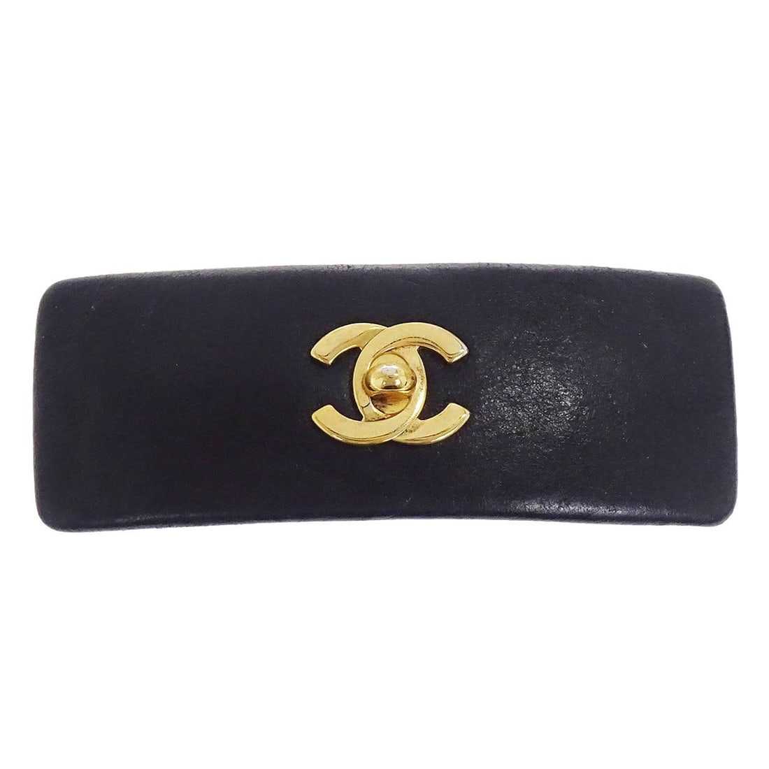 Gold Plated Barrette with Black Leather CC Turnlock by Chanel: Gold Plated Barrette with Black Leather CC Turnlock by Chanel This Chanel hair barrette features a turnlock CC design in black and gold, crafted with gold-plated material. A stylish hair accessory mad