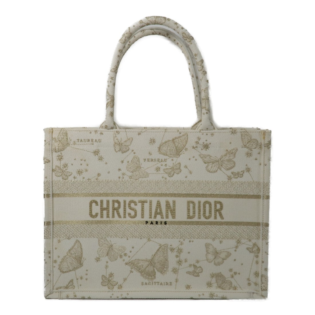 Dior Medium Oblique Canvas Tote Bag White Gold: Dior Medium Oblique Canvas Tote Bag White Gold This Christian Dior Book Tote Medium is crafted from canvas in a gold oblique pattern, featuring a white exterior. Designed for women, it offers a spacio