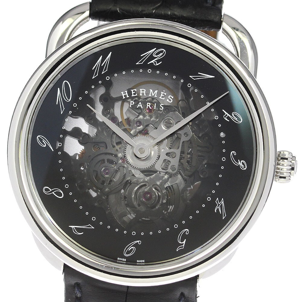 Hermes Arceau Skerret AR.710 Automatic Men's Wristwatch: Hermes Arceau Skerret AR.710 Automatic Men's Wristwatch This is a pre-owned HERMES AR.710 Arceau Skerret men's wristwatch, crafted in Switzerland. The watch features a stainless steel case and a black