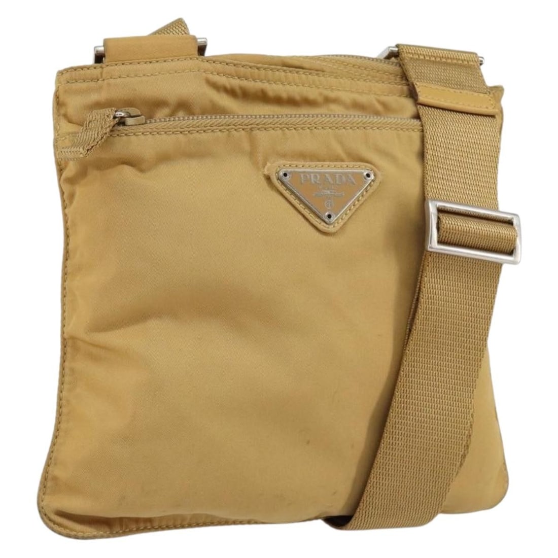 Prada beige nylon women s shoulder bag with guarantee card: Prada beige nylon women s shoulder bag with guarantee card This PRADA shoulder bag features a beige and silver nylon exterior and is designed for women. Made in Italy, the bag offers a practical and s