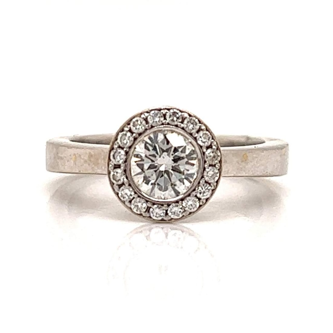 Platinum 0.90 Ct. Diamond Ring with 0.70 Ct. Center Stone: Platinum 0.90 Ct. Diamond Ring with 0.70 Ct. Center Stone This exquisite platinum diamond ring features a stunning 0.70 Ct. diamond with I color and SI1 clarity, complemented by 16 additional diamonds