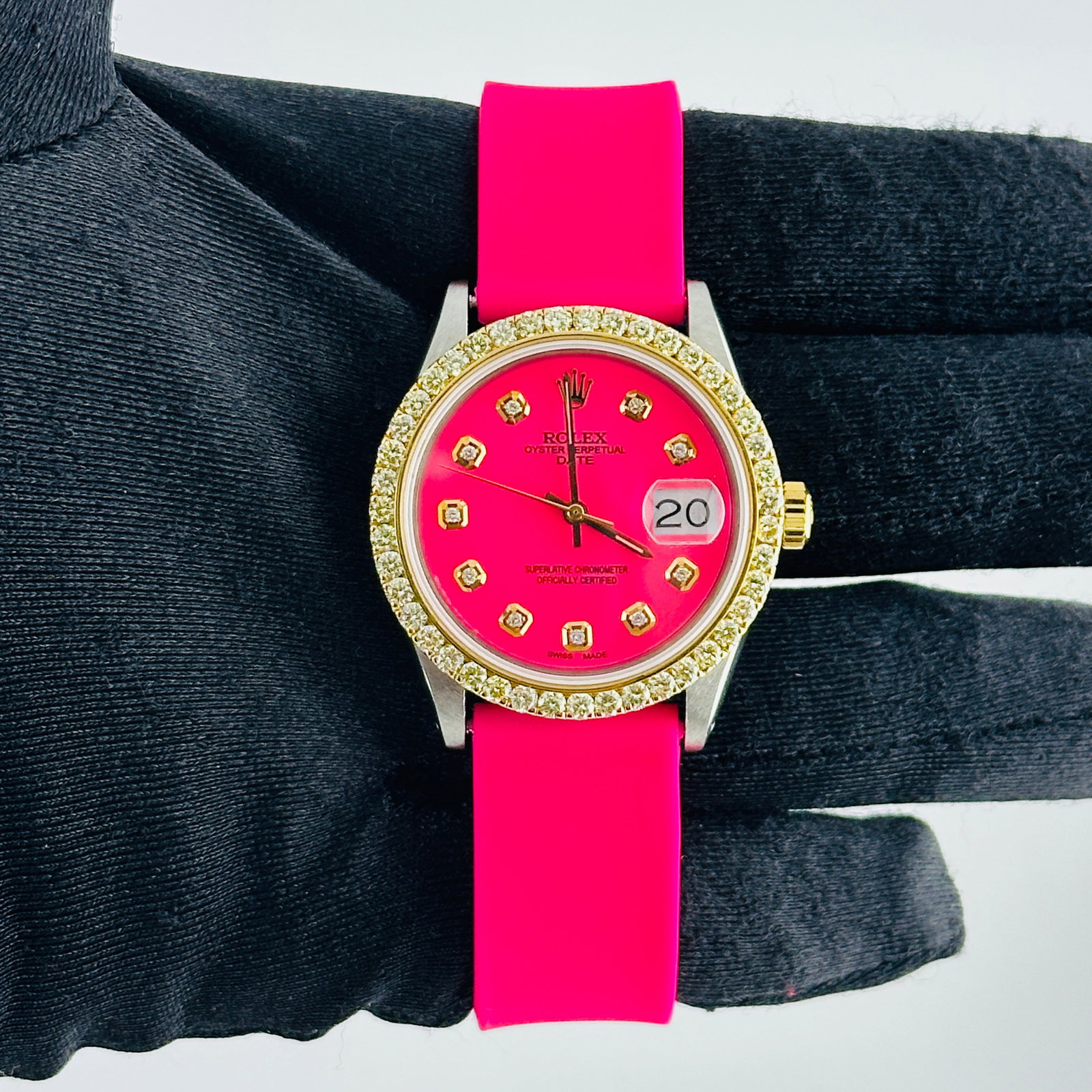 Ladies Aftermarket Pink Diamond Dial Watch with Pink Rubber Band Ref 6694: Ladies Aftermarket Pink Diamond Dial Watch with Pink Rubber Band Ref 6694 This ladies Rolex Oyster Perpetual Date features an aftermarket pink dial with yellow diamond markers and a prong yellow gold 
