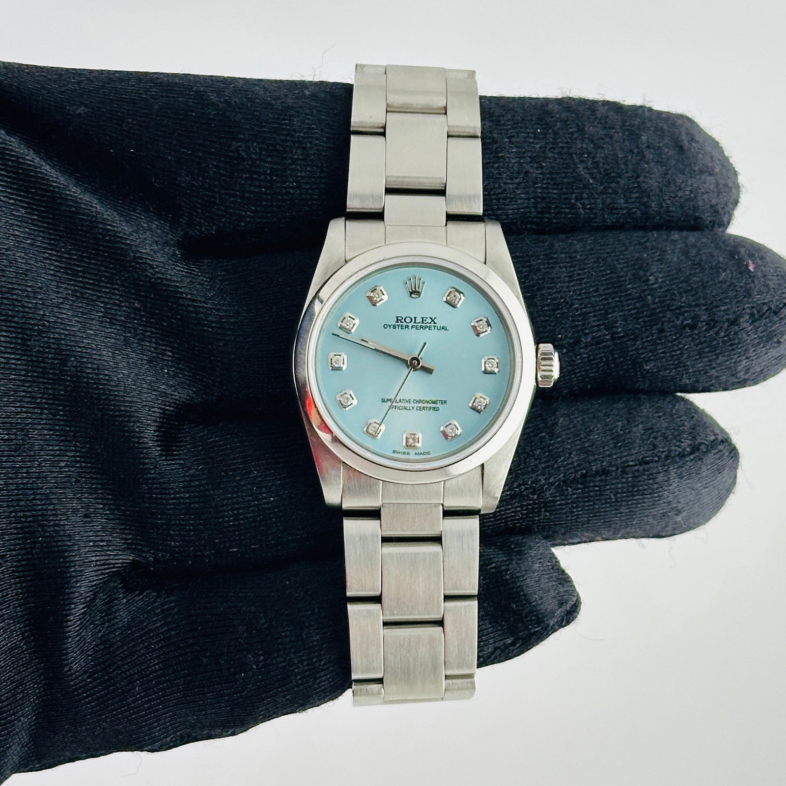 Ladies Rolex Oyster Perpetual 67480 with Aftermarket Ice Blue Diamond Dial: Ladies Rolex Oyster Perpetual 67480 with Aftermarket Ice Blue Diamond Dial This Rolex Oyster Perpetual watch features a silver dial, smooth bezel, and classic Oyster bracelet. Designed for ladies, it 