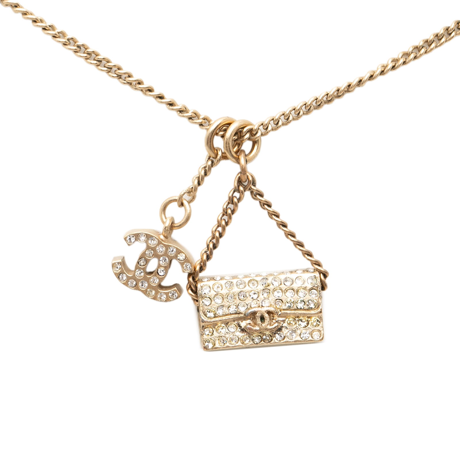 Chanel Gold Tone Rhinestone CC Pendant Necklace: Chanel Gold Tone Rhinestone CC Pendant Necklace This Chanel necklace features a gold tone metal body with a pendant adorned with rhinestone embellishments. It is designed with a spring ring closure an
