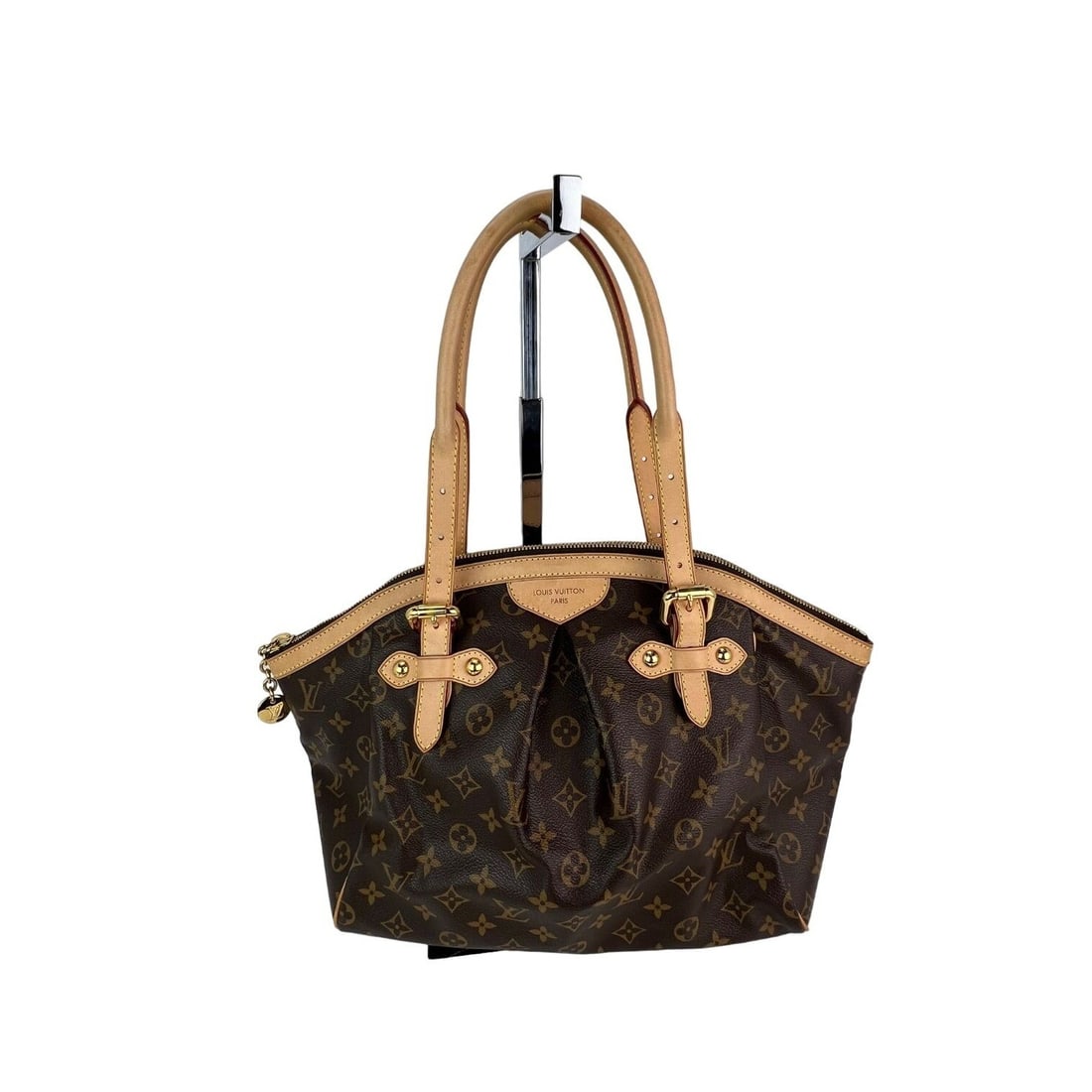 Louis Vuitton Tivoli GM Monogram Shoulder Bag with Dust Bag and Charm: Louis Vuitton Tivoli GM Monogram Shoulder Bag with Dust Bag and Charm The Louis Vuitton Tivoli GM Monogram Shoulder Bag is a stylish and iconic accessory that features a classic oval shape and a sophi