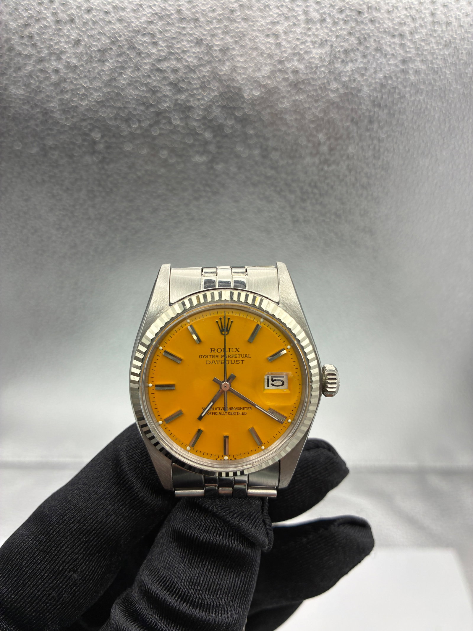 Rolex Datejust aftermarket yellow dial Ref 1601 Jubilee bracelet: Rolex Datejust aftermarket yellow dial Ref 1601 Jubilee bracelet This Rolex Datejust features an aftermarket yellow dial and is paired with a folded Jubilee bracelet. The watch has a fluted bezel and 
