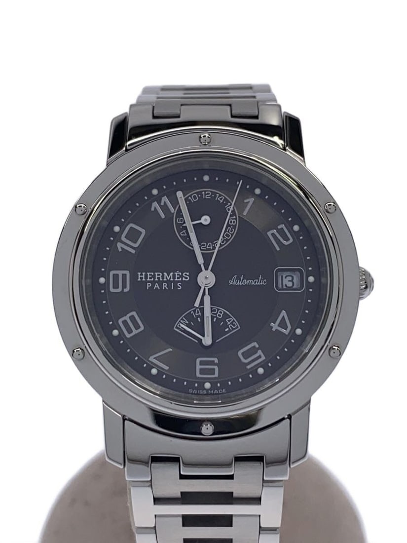 Hermes Clipper Swiss men's wristwatch: Hermes Clipper Swiss men's wristwatch This HERMES Clipper men's wristwatch features Swiss-sourced materials and showcases a classic design. It is pre-owned with slight signs of use and offers a round 