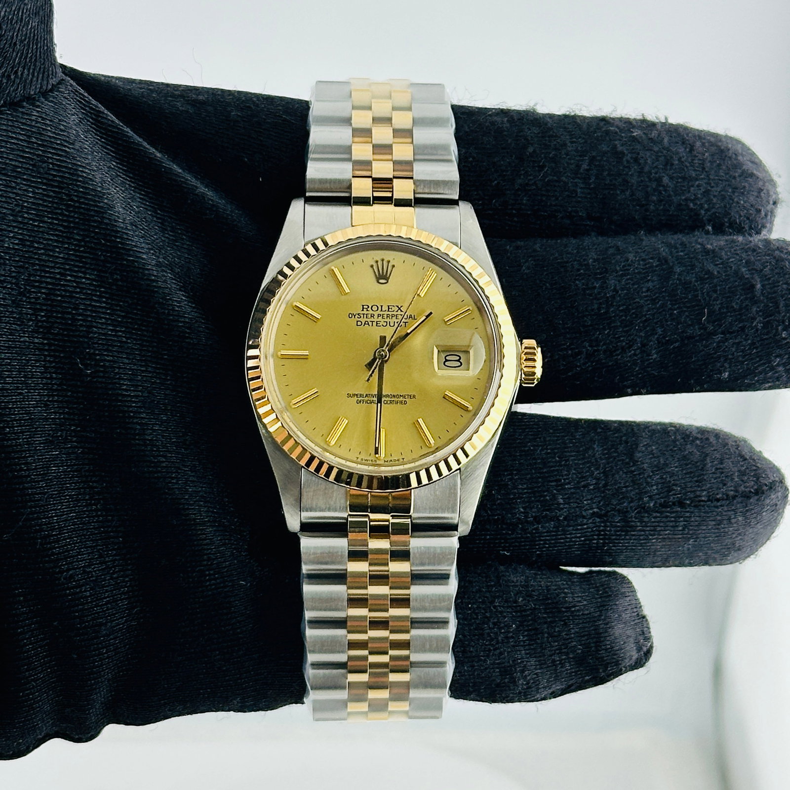 Rolex Datejust 16013 Champagne Stick Dial Fluted Bezel: Rolex Datejust 16013 Champagne Stick Dial Fluted Bezel This Rolex Datejust features a champagne stick dial and is paired with an aftermarket Jubilee bracelet. The watch has a fluted bezel and is desig