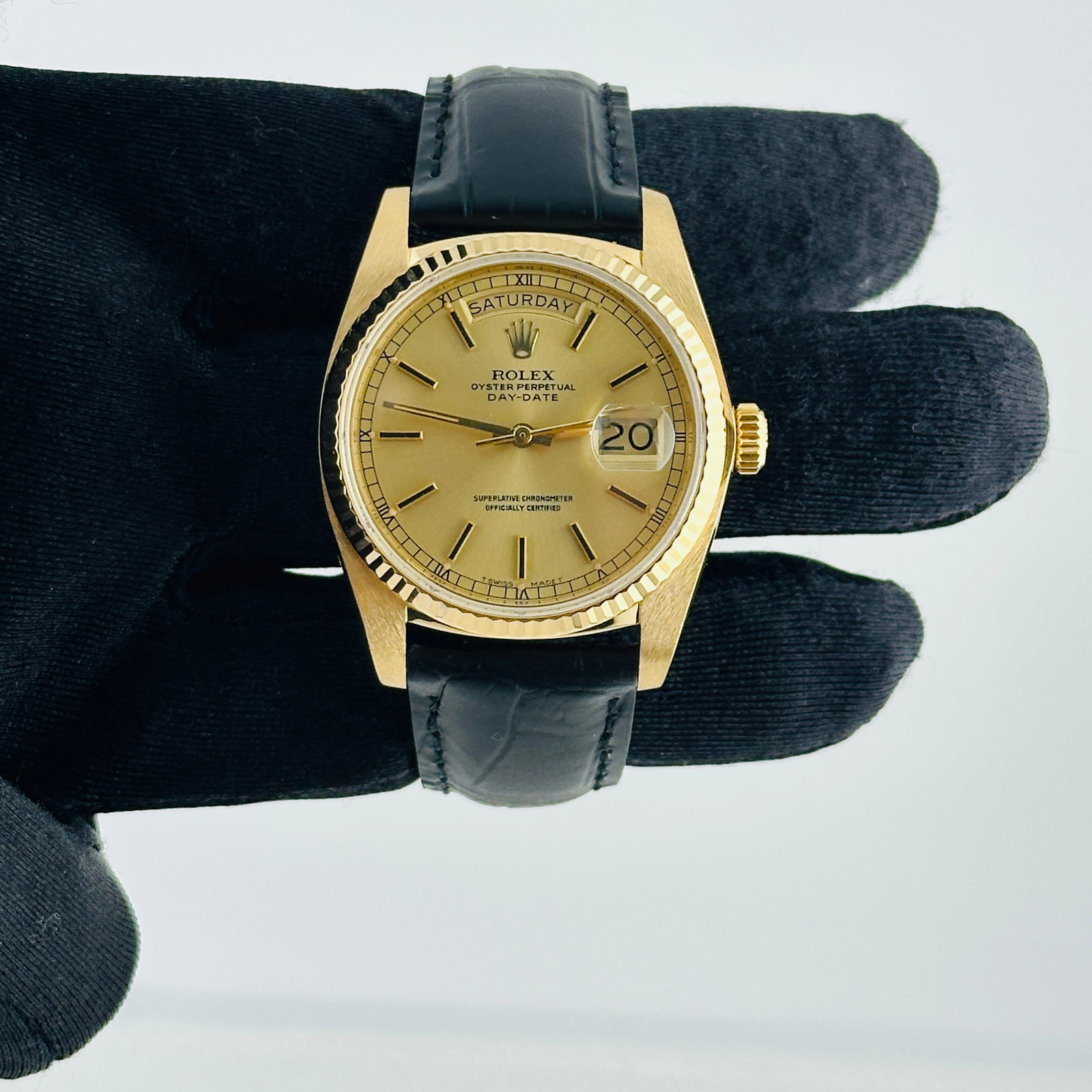 Day Date Reference 18038 Champagne Stick Dial Watch with Aftermarket Leather Strap: Day Date Reference 18038 Champagne Stick Dial Watch with Aftermarket Leather Strap This Rolex Day Date features a champagne stick dial with a fluted bezel and is fitted with an aftermarket leather bra