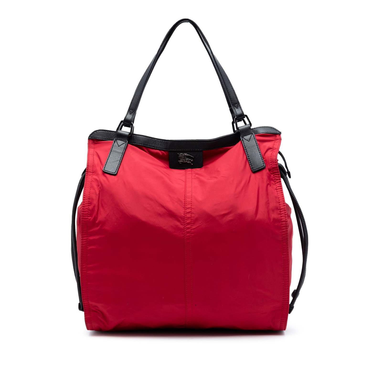Burberry red nylon tote with leather trim: Burberry red nylon tote with leather trim This Burberry Buckleigh tote features a durable nylon body accented with leather trim and flat leather straps. The bag is designed with both top zip and draws