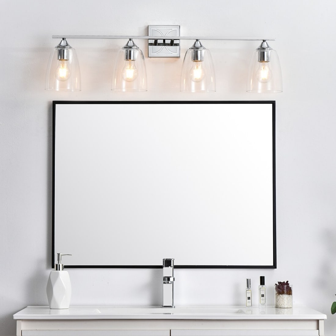 Chrome Glass Wall Sconce Harris 33.5 in 4-Light: Chrome Glass Wall Sconce Harris 33.5 in 4-Light This modern wall sconce light fixture features a polished chrome finish and four dome-shaped clear glass shades. Designed for versatile use, it is suita