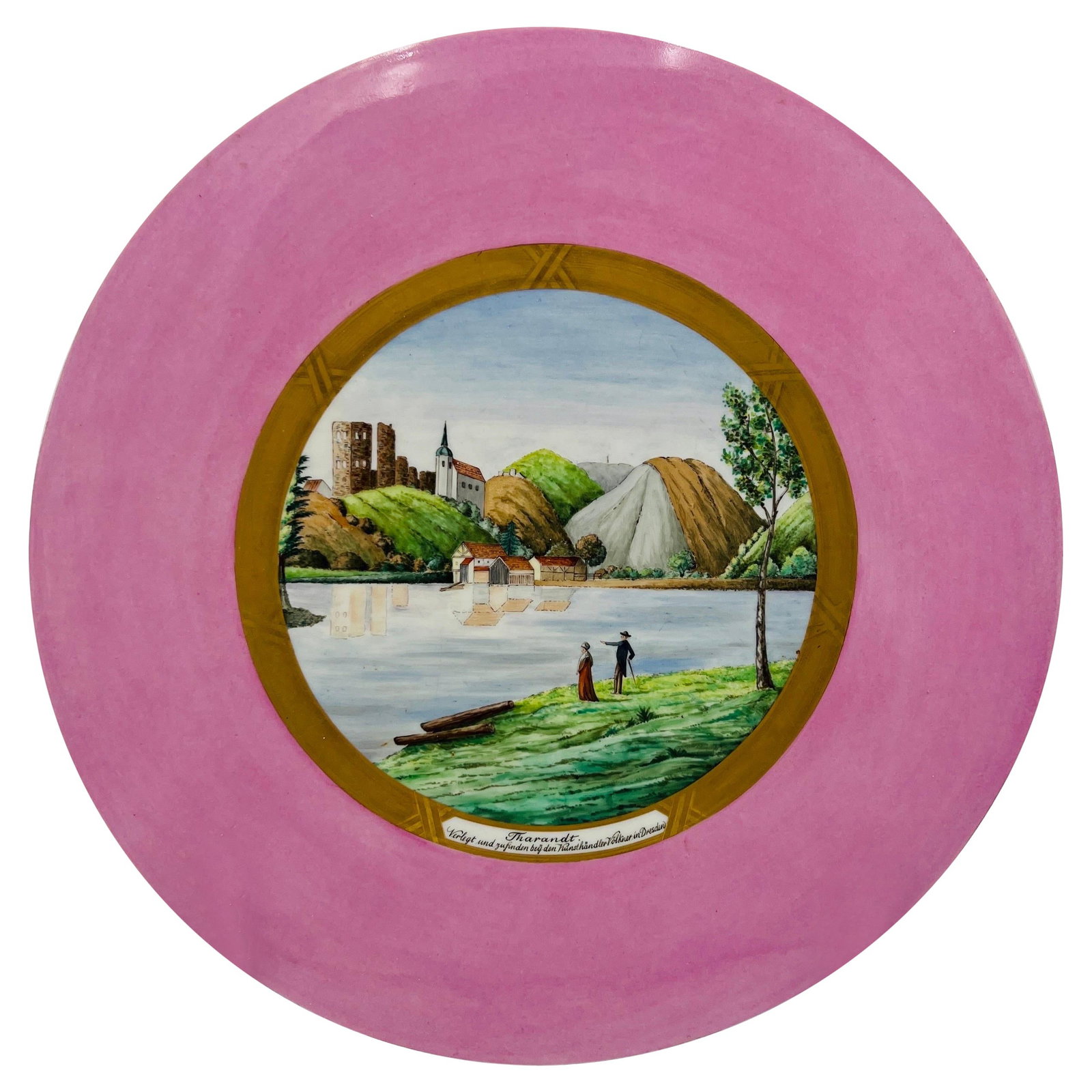 KPM Porcelain Plaque View of Tharandt Early 20th Century: KPM Porcelain Plaque View of Tharandt Early 20th Century This exquisite antique KPM porcelain plaque features a stunning countryside painting of Tharandt, set against a pink body. Accentuated by a gil