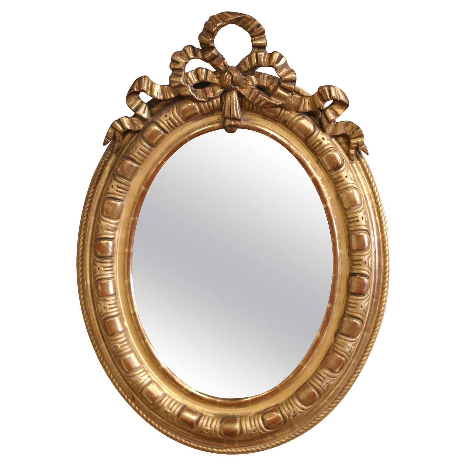 Antique 19th Century French Louis XVI Giltwood Oval Mirror: Antique 19th Century French Louis XVI Giltwood Oval Mirror This exquisite 19th Century French Louis XVI Carved Giltwood Oval Wall Mirror is a stunning addition to any home decor. Crafted in France aro