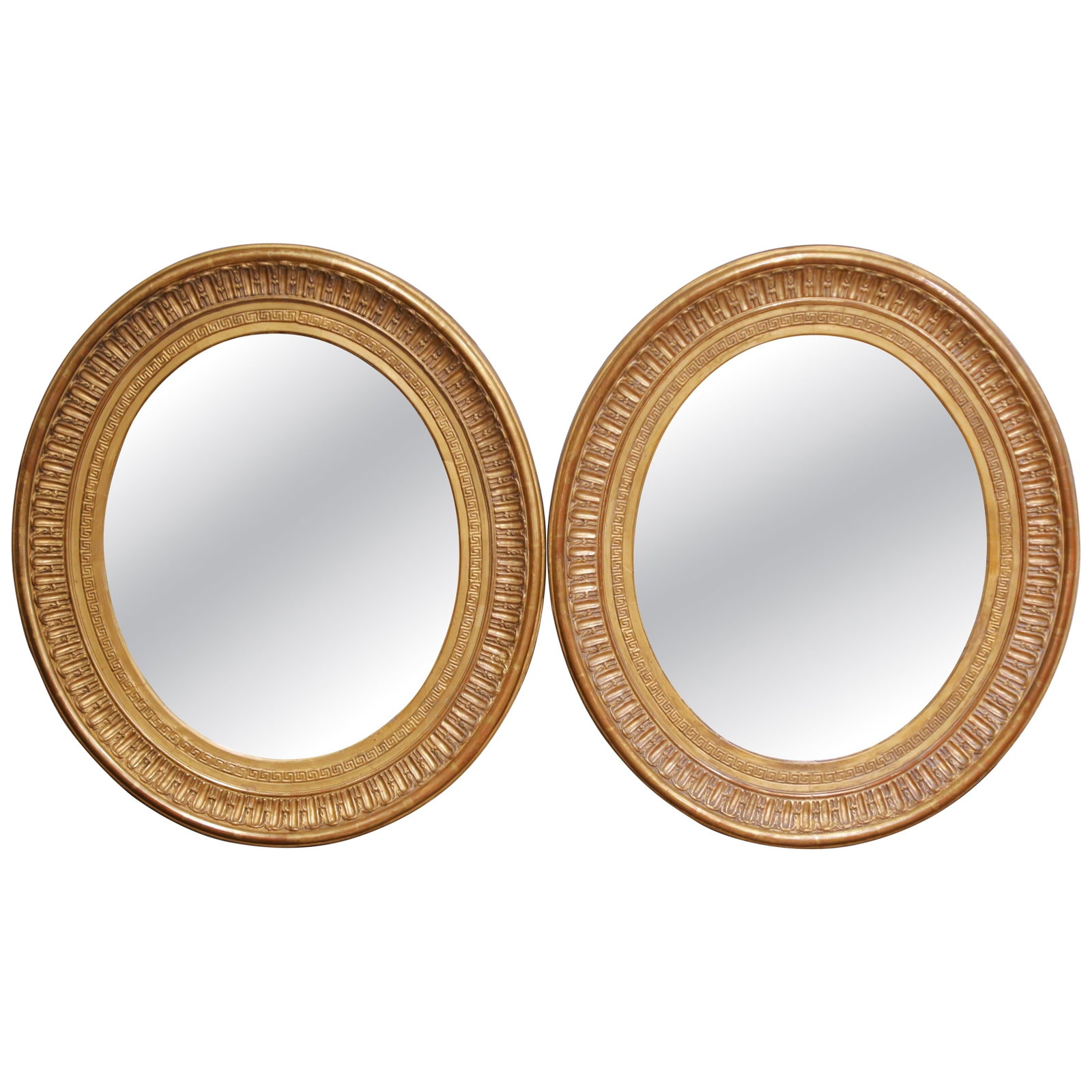 Set of 2 Antique French Louis XVI Giltwood Oval Wall Mirrors Circa 1860: Set of 2 Antique French Louis XVI Giltwood Oval Wall Mirrors Circa 1860 This pair of antique French Louis XVI oval wall mirrors dates to circa 1860. Each mirror features a hand-carved giltwood frame w