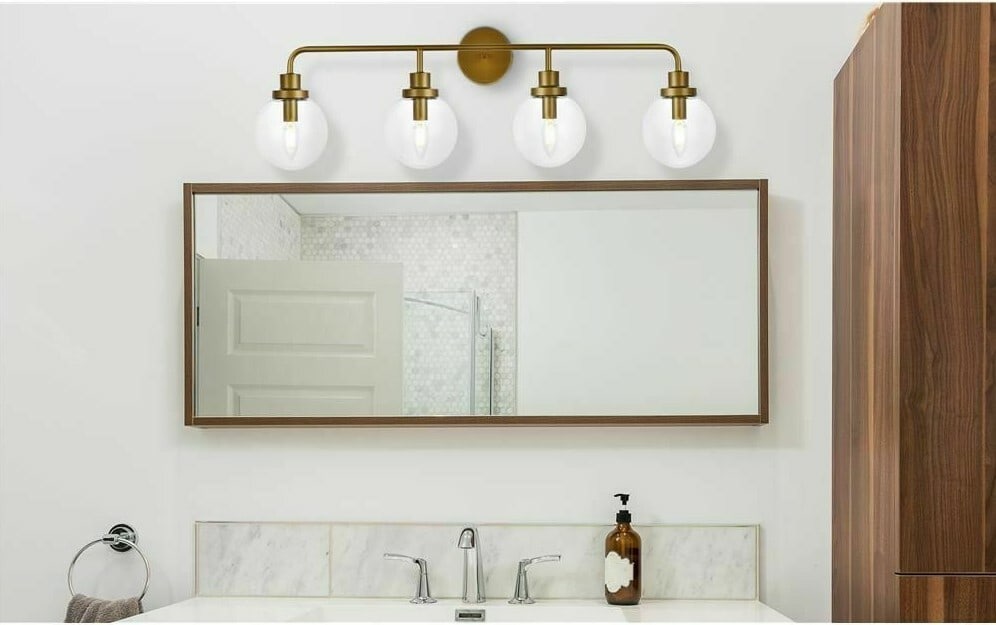 Hanson Brass 4 Light Wall Sconce with Clear Glass Shade: Hanson Brass 4 Light Wall Sconce with Clear Glass Shade This modern wall sconce features a brass metal frame with four lights and clear glass round shades. The fixture is designed for hardwired instal