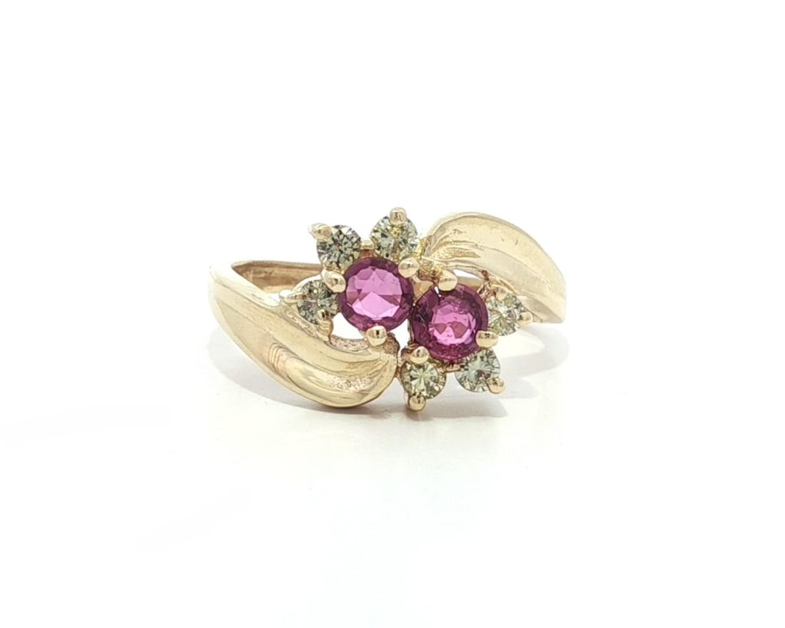 Estate Yellow Gold Pink Sapphire Diamond Floral Bypass Ring: Estate Yellow Gold Pink Sapphire Diamond Floral Bypass Ring This exquisite estate bypass band ring features a stunning flower cluster design, highlighted by two natural pink sapphires and six shimmeri