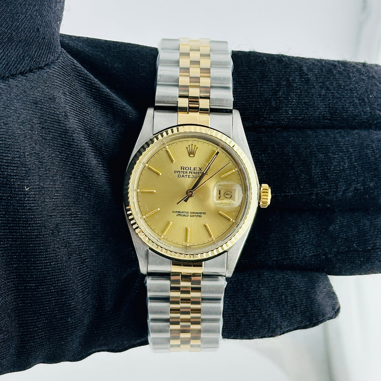 Rolex Datejust 16013 Champagne Stick Dial Aftermarket Jubilee Bracelet: Rolex Datejust 16013 Champagne Stick Dial Aftermarket Jubilee Bracelet This Rolex Datejust features a champagne stick dial and a fluted bezel, paired with an aftermarket Jubilee bracelet. The watch is