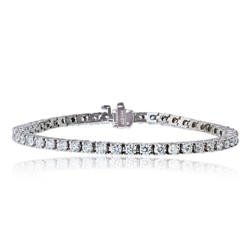 5.01 Carat Diamond Tennis Bracelet in 14K White Gold Four Prong Setting: 5.01 Carat Diamond Tennis Bracelet in 14K White Gold Four Prong Setting This 14K white gold tennis bracelet features 49 round brilliant cut natural diamonds with a total weight of approximately 5.01 c