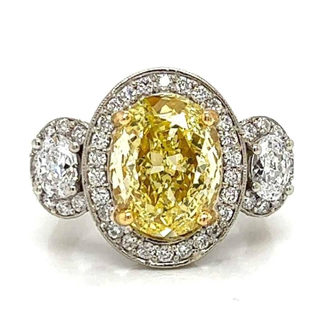 GIA Certified 3.90 Ct Fancy Yellow Diamond Ring in Platinum & 18K Gold: GIA Certified 3.90 Ct Fancy Yellow Diamond Ring in Platinum & 18K Gold This exquisite ring features a stunning GIA Certified 3.90 Ct. fancy yellow diamond, elegantly set in a combination of platinum a