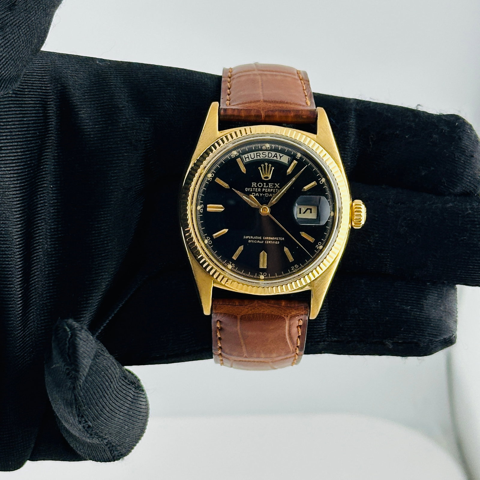 Rolex Day-Date 6611 Mens Watch Black Dial Fluted Bezel Aftermarket Leather: Rolex Day-Date 6611 Mens Watch Black Dial Fluted Bezel Aftermarket Leather This Rolex Day-Date features a black and gold stick dial paired with a fluted bezel. The watch is equipped with an aftermarke