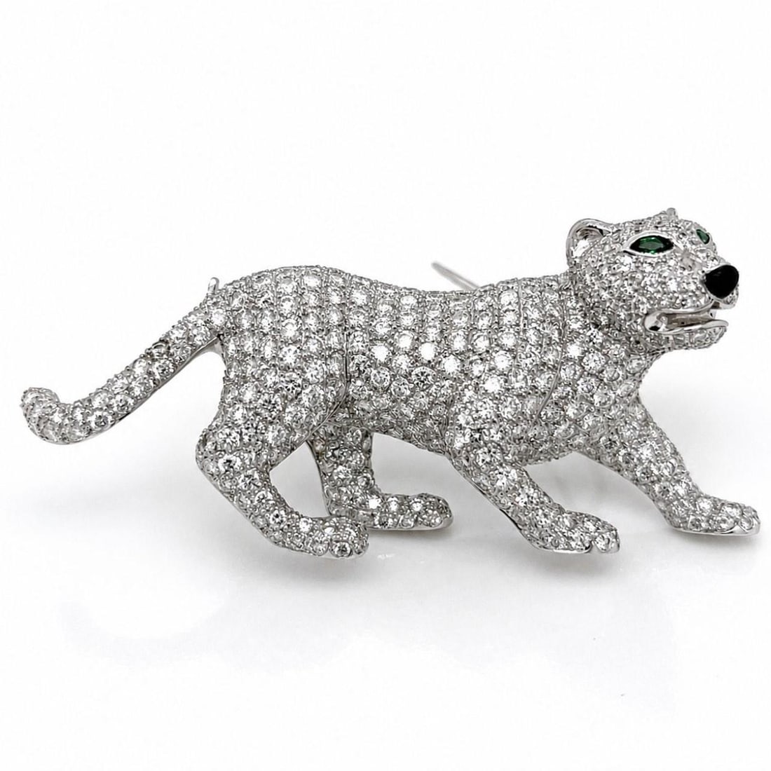 Panther Brooch in 18K White Gold with Diamond and Tsavorite Eyes: Panther Brooch in 18K White Gold with Diamond and Tsavorite Eyes This elegant brooch is crafted from 18K white gold and designed in the shape of a panther. It features approximately 10.00 carats of di