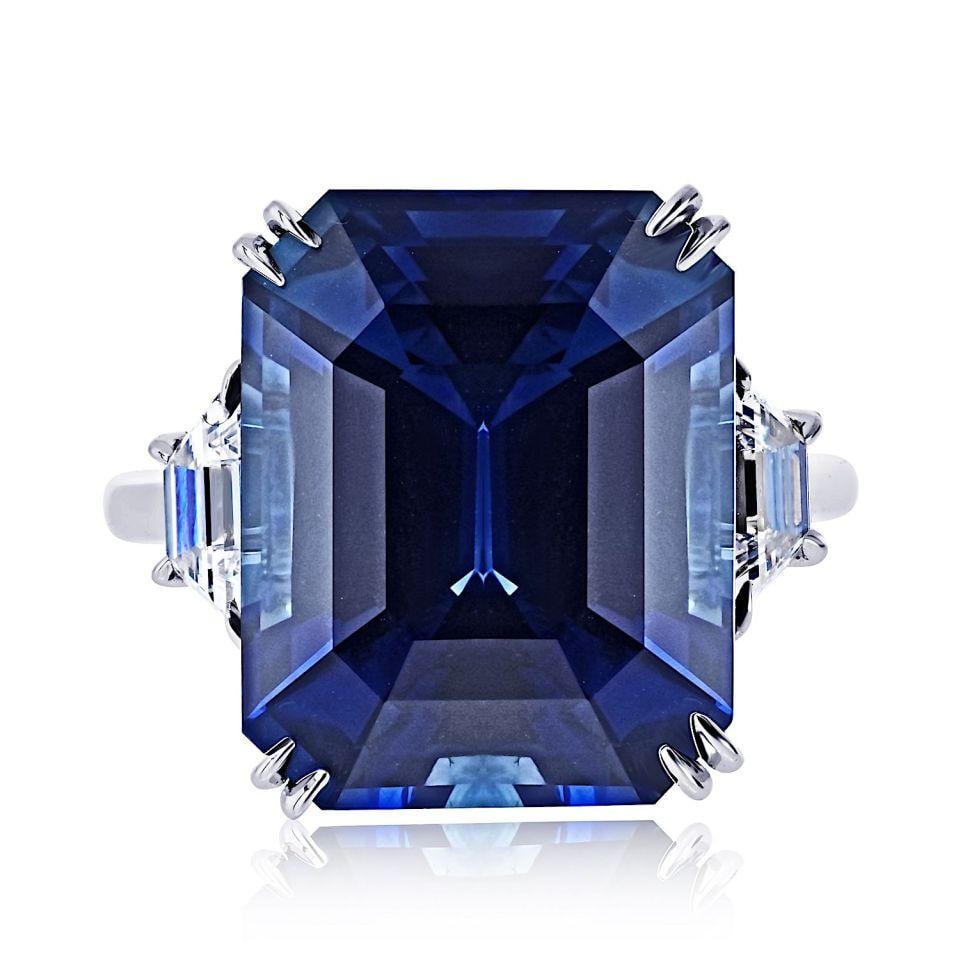 Platinum ring with GIA certified Sri Lanka blue sapphire and diamonds: Platinum ring with GIA certified Sri Lanka blue sapphire and diamonds This elegant three-stone ring features a striking 14.98 carat blue sapphire from Sri Lanka, certified by GIA and noted as heated. 