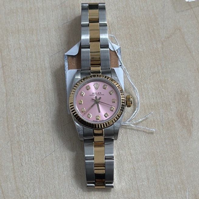 Ladies Rolex Oyster Perpetual 67193 Pink Yellow Diamond Dial Oyster Bracelet: Ladies Rolex Oyster Perpetual 67193 Pink Yellow Diamond Dial Oyster Bracelet This ladies' Rolex Oyster Perpetual features a distinctive Aftermarket pink dial with yellow diamond markers. The watch is 