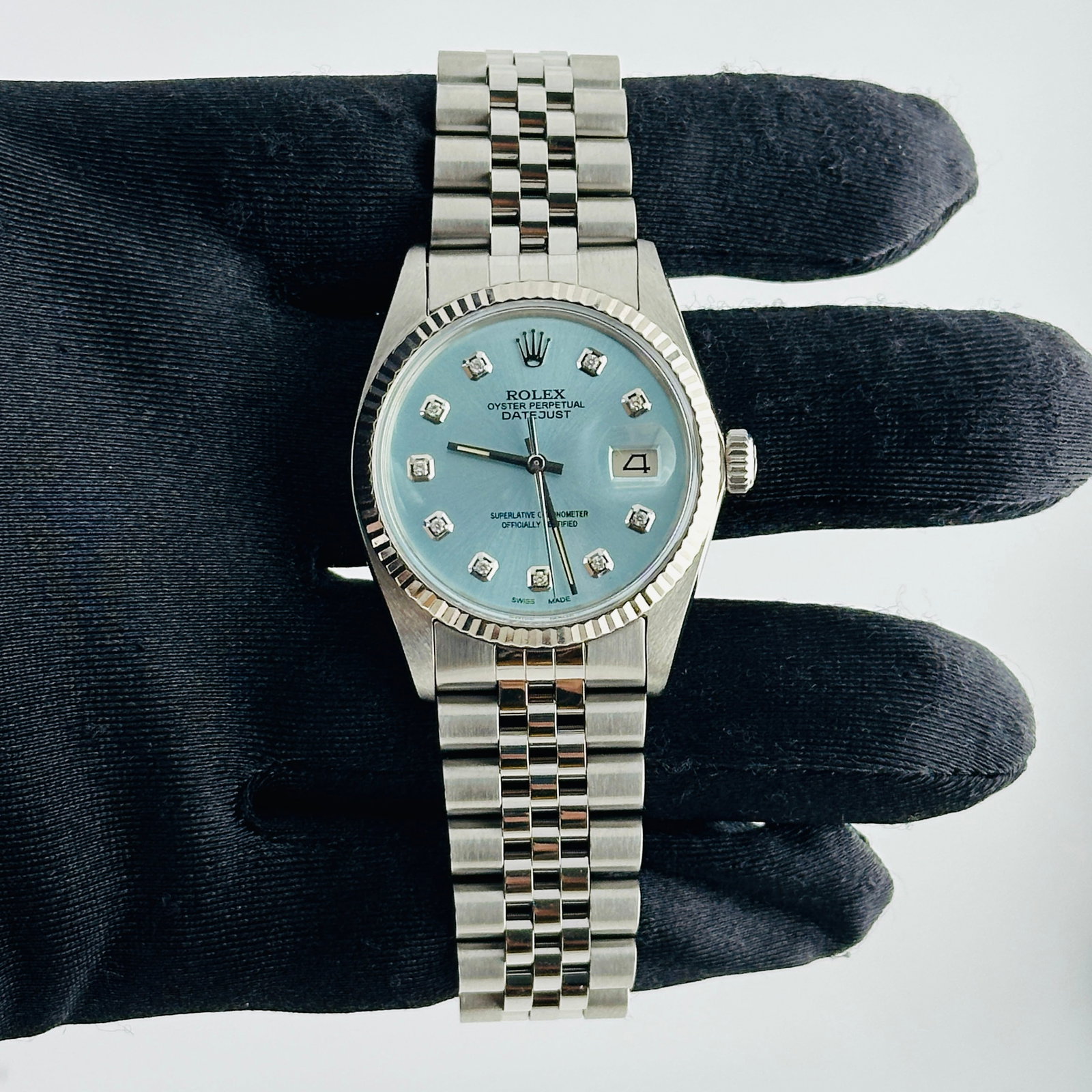 Rolex Datejust aftermarket ice blue diamond dial Jubilee bracelet Ref 16014: Rolex Datejust aftermarket ice blue diamond dial Jubilee bracelet Ref 16014 This is a Rolex Datejust men's watch featuring an Aftermarket ice blue diamond dial, complemented by a fluted bezel and a D-