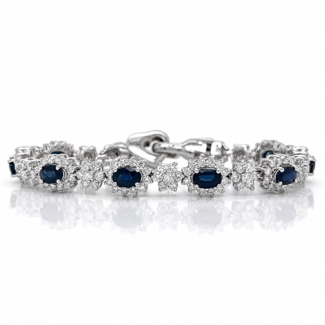 18K White Gold Bracelet with Sapphire and Diamond Stones 6.75 inches: 18K White Gold Bracelet with Sapphire and Diamond Stones 6.75 inches This elegant bracelet is crafted from 18K white gold and features nine sapphires with a total approximate weight of 5.00 carats. Th